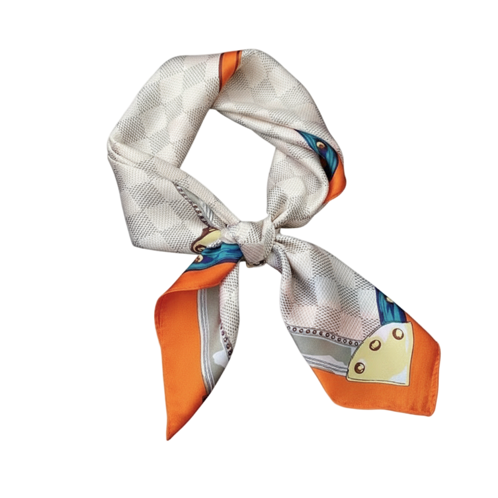 Decorative scarf with orange and blue accents on a black tray held by a hand.